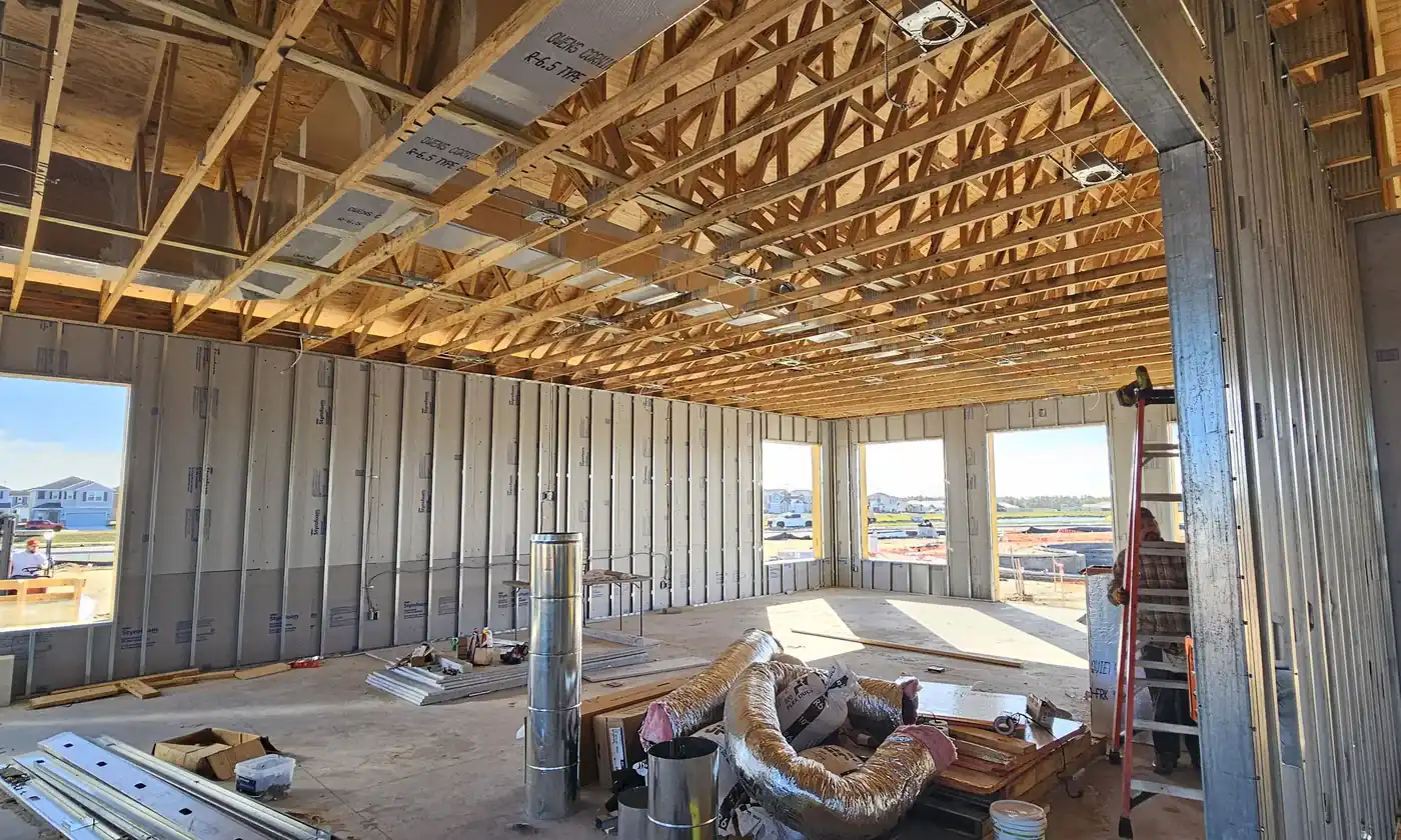 New construction clubhouse interior with open trusses during low-voltage prewire