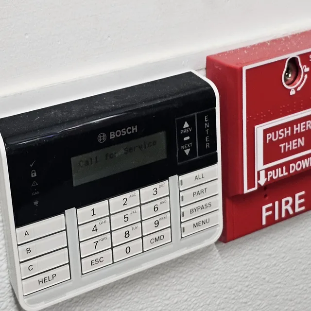 Bosch alarm keypad installed beside a manual fire alarm pull station, Clermont, FL