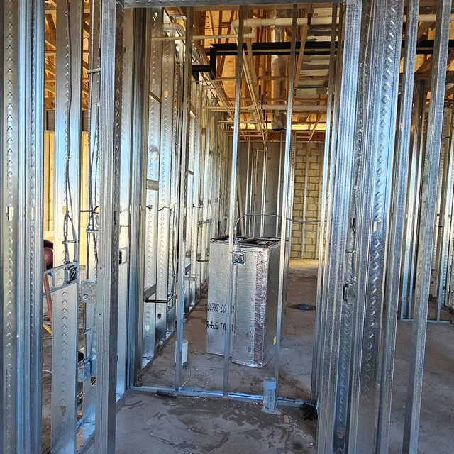 Metal stud framing with low-voltage rough-in on a commercial new construction site, Winter Haven, FL