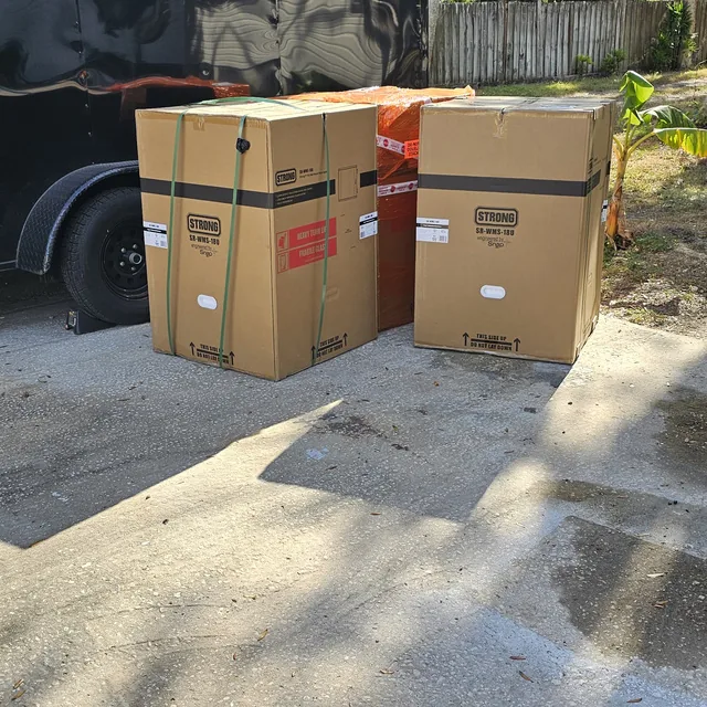 Boxed network rack cabinets delivered to a jobsite beside the SPCom equipment trailer, Winter Haven, FL