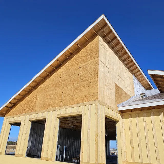 Exterior of a new construction clubhouse with block walls and plywood gable framing, Winter Haven, FL
