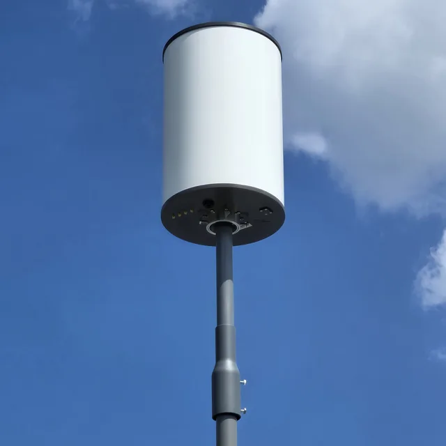 Outdoor wireless antenna on a mast above two dome security cameras under an eave, Orlando, FL