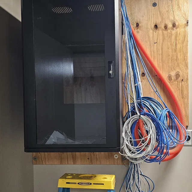 Wall-mount network cabinet with orange fiber innerduct and Cat6 cable roughed in, Winter Haven, FL